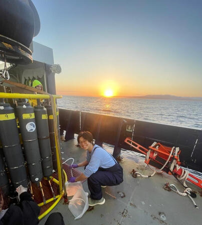 Sampling seawater from the CTD rosette at dawn aboard the R/V Sally Ride